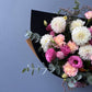Bouquet of flowers with pink and white flowers against a blue background