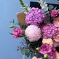 Bouquet of pink and white flowers with a blue background